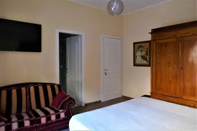 a bedroom with a bed and a tv and a couch at La Tana di Sofia in Rome