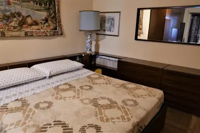 a bedroom with a bed and a mirror at La Tana di Sofia in Rome