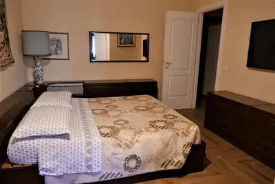 a bedroom with a bed and a flat screen tv at La Tana di Sofia in Rome