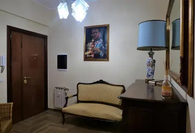 a room with a chair and a desk and a lamp at La Tana di Sofia in Rome