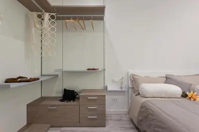 a bedroom with a bed and a wooden dresser at The Apartment Trastevere - Ba.home in Rome