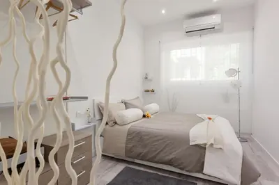 a bedroom with a bed and a large tree at The Apartment Trastevere - Ba.home in Rome
