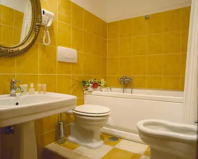 a bathroom with a sink and a toilet and a bath tub at Orange Garden Guest House in Rome