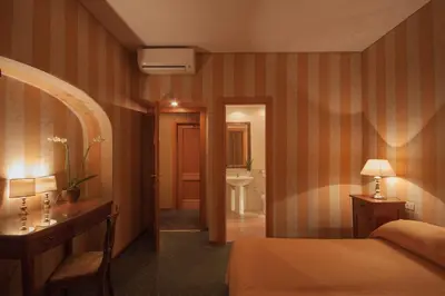 a hotel room with a bed and a bathroom at Orange Garden Guest House in Rome