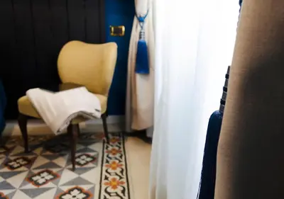 a room with a chair and a white curtain at Eterna Roma in Rome
