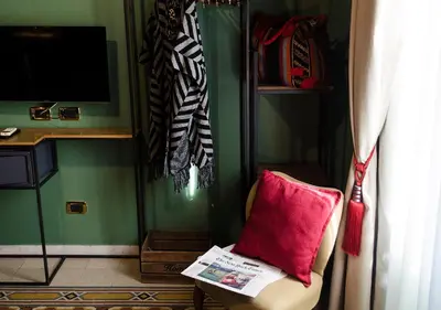 a living room with a red pillow on a chair at Eterna Roma in Rome