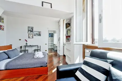 a bedroom with a bed and a couch at Fori Imperiali Apartment in Rome