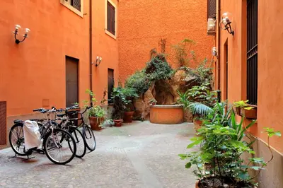 two bikes parked next to a building with plants at Fori Imperiali Apartment in Rome