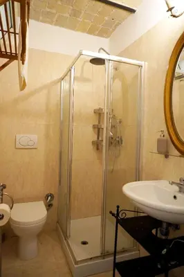 a bathroom with a shower and a toilet and a sink at Steps from the Vatican Guesthouse in Rome