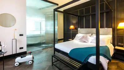 a bedroom with a large bed with a glass wall at Hotel The Haven Roma in Rome