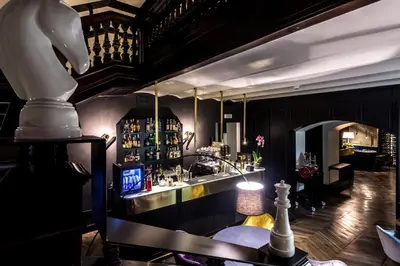 a room with a bar with a counter and a chess at Hotel The Haven Roma in Rome