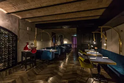 a dining room with tables and yellow chairs at Hotel The Haven Roma in Rome