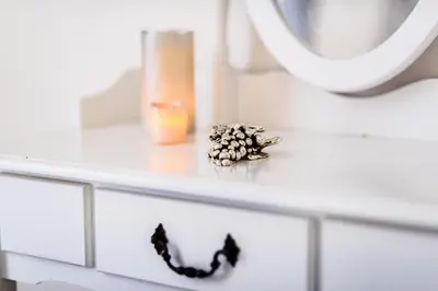 a white dresser with a mirror and a necklace on it at Saint Peter Cozy Apartment in Rome