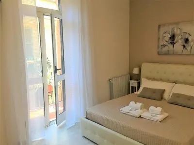 a bedroom with a bed with towels on it at Saint Peter Cozy Apartment in Rome
