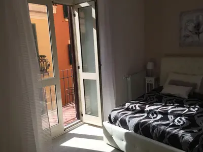 a bedroom with a bed next to a sliding glass door at Saint Peter Cozy Apartment in Rome