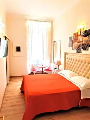 a bedroom with a large bed with a red blanket at Santa Maria Maggiore in Rome