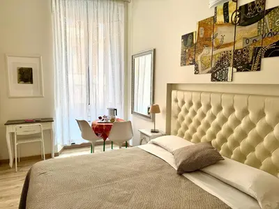 a bedroom with a bed and a table and a window at Santa Maria Maggiore in Rome