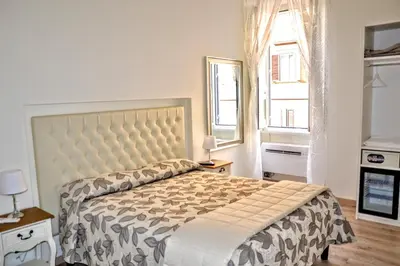 a bedroom with a large bed and a window at Santa Maria Maggiore in Rome