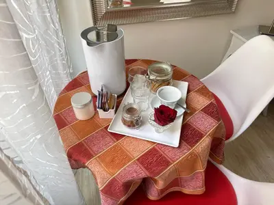a table with a tray with a cup and roses on it at Santa Maria Maggiore in Rome