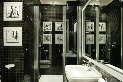 a bathroom with a shower and a sink and mirrors at Hotel Kennedy in Rome