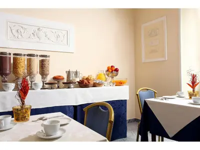 a dining room with two tables and a counter at Hotel Kennedy in Rome