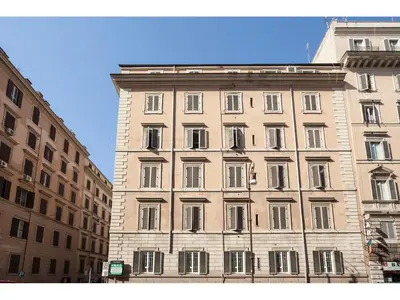 a large building with many windows on a street at Hotel Kennedy in Rome