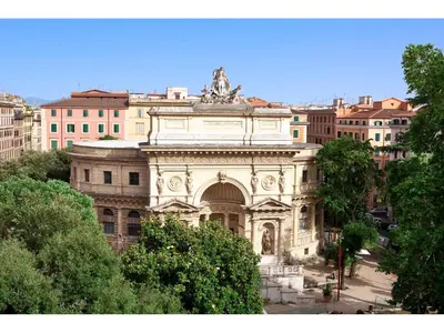 a large building with a statue on top of it at Hotel Kennedy in Rome