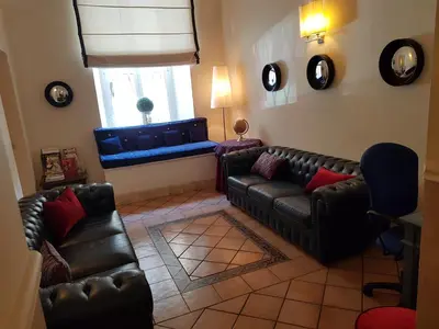 a living room with leather couches and a window at Hotel Kennedy in Rome