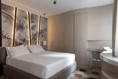 a bedroom with a white bed and a desk at BDB Rooms Navona in Rome
