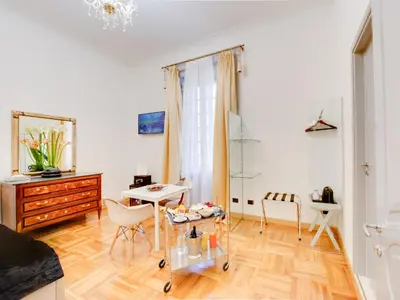 a living room with a table and a desk at Queen Palace Suites in Rome