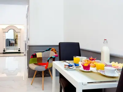 a dining room with a table with food on it at Queen Palace Suites in Rome