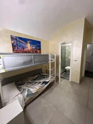 a bedroom with a bunk bed with a painting on the wall at Favola Romana - Guest House in Rome