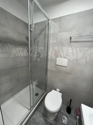 a bathroom with a toilet and a glass shower at Favola Romana - Guest House in Rome