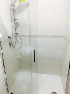 a shower with a glass door in a bathroom at Favola Romana - Guest House in Rome