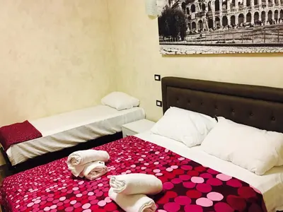 a room with two beds with towels on them at Favola Romana - Guest House in Rome