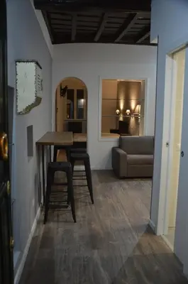a living room with a table and a couch at SuityRHome RioneMonti118 in Rome