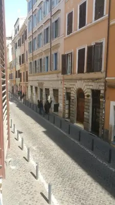 an empty street in a city with buildings at SuityRHome RioneMonti118 in Rome