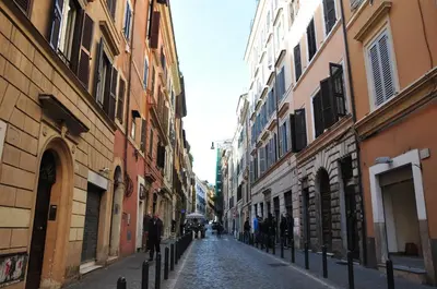 an alley with buildings and people walking down a street at SuityRHome RioneMonti118 in Rome