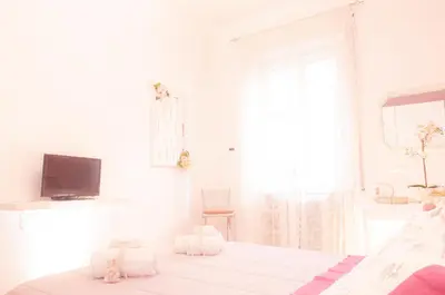 a white room with a bed and a television at Ninuphar Maison - alloggio per uso turistico in Rome