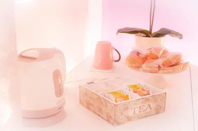 a table with a tea kettle and a box of food at Ninuphar Maison - alloggio per uso turistico in Rome