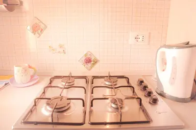 a kitchen stove top with a stove top oven at Ninuphar Maison - alloggio per uso turistico in Rome