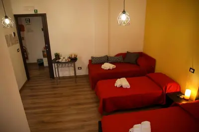 a living room with a red couch and a table at Nonna's house in Rome