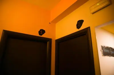 two black doors in a room with orange walls at Nonna's house in Rome