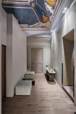 a room with a ceiling with a painting on the wall at Hotel dei Barbieri in Rome