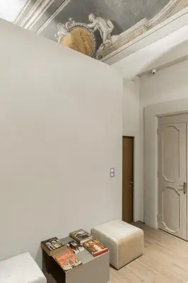 a room with a bed and a table with books at Hotel dei Barbieri in Rome