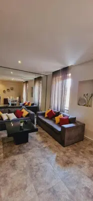 a large living room with two couches and a table at Fornaci Guest House in Rome