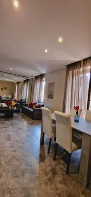 a living room with a table and chairs and a couch at Fornaci Guest House in Rome