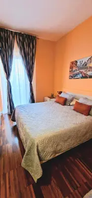 a bedroom with a large bed and a window at Fornaci Guest House in Rome