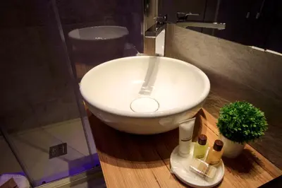 a bathroom with a white sink and a shower at K Rooms in Rome