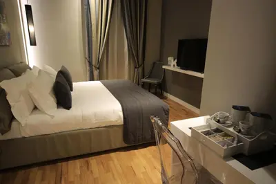 a bedroom with a bed and a table with a television at K Rooms in Rome